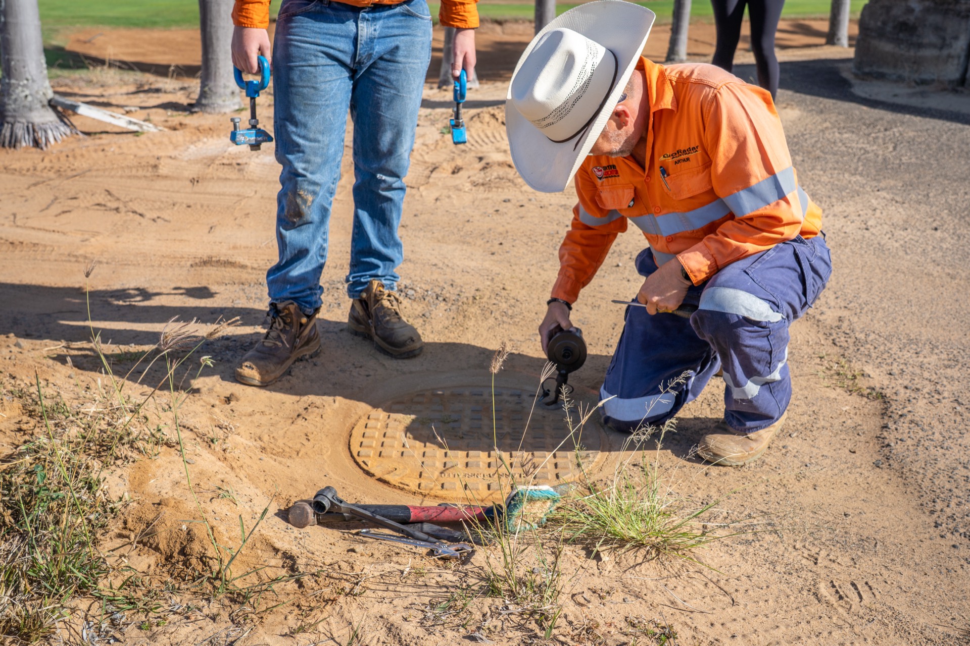 GeoRadar operator marking located services on a gravel road